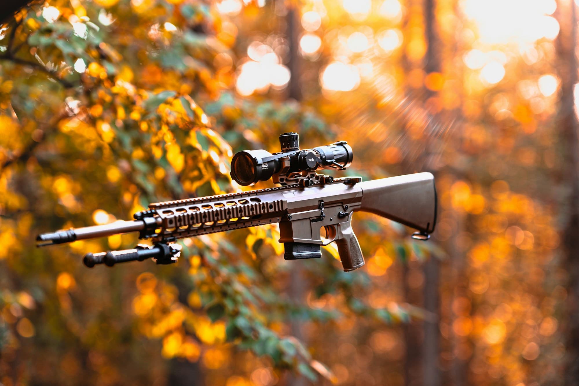Stock photograph of a rifle in woodland; illustrative equipment.