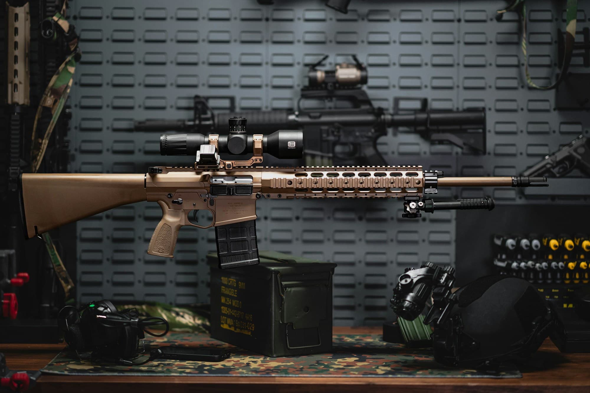 Stock photograph of a rifle and equipment on a workbench.